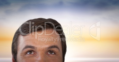 Man looking up with sunset background