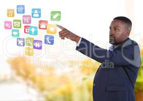 App interface and Businessman pointing touching air in front of greenery