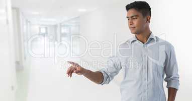 Businessman touching air in front of corridor