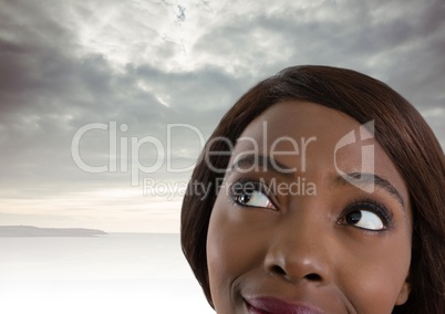 Woman looking up with cloudy background