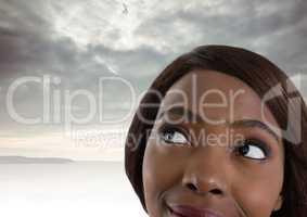Woman looking up with cloudy background