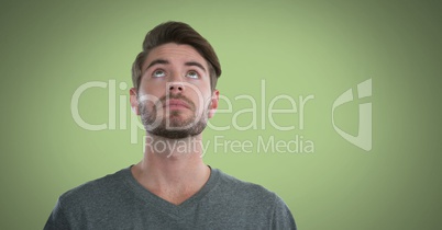 Man looking up with green background