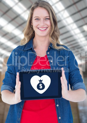 Woman holding tablet with money bag icon and heart icon