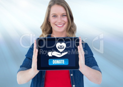 Woman holding tablet with donate button and hand giving money with love icon to charity