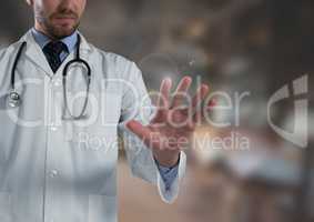 Doctor man touching air in front of blurred background