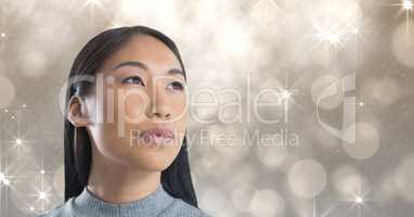 Woman looking up with sparkling glamorous background