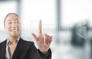 Businesswoman touching air in front of blurred office