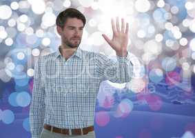 Businessman touching air with open hand in front of sparkling lights
