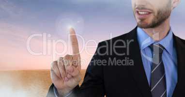 Businessman touching air in front of desert