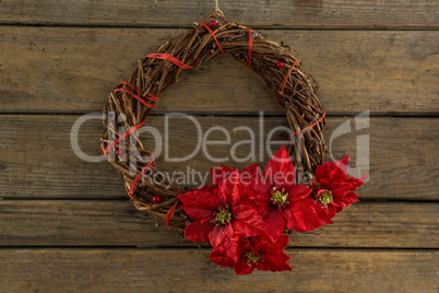 Overhead view of wreath with red poinsettia flowers