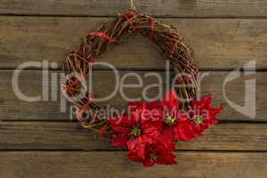 Overhead view of wreath with red poinsettia flowers