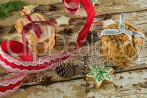 Cookies and christmas decoration on wooden plank
