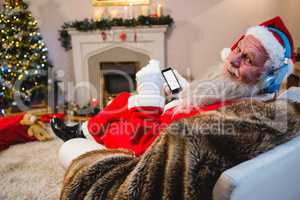 Santa claus using mobile phone at home