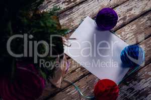 Christmas decoration and blank paper on wooden plank