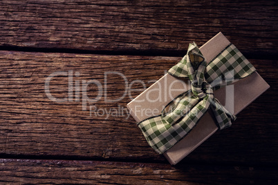 Wrapped gift box on wooden plank