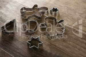 Various cookie cutters on wooden table