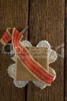 Wrapped gift, ribbon and scissors on wooden plank