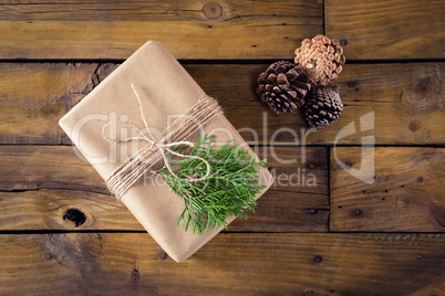 Gift box, fir and pine cone on wooden table