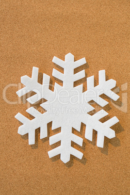 White snowflake on brown background