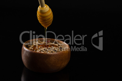 Honey being poured into cereal bran sticks