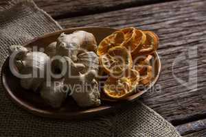Gingers and dried orange sliced on plate