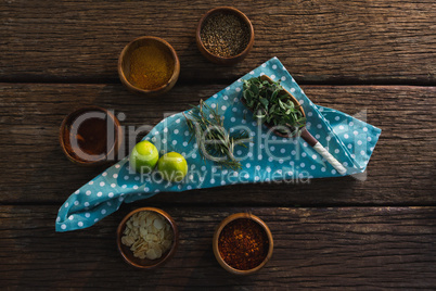 Various spices with herbs on wooden table