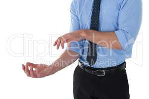 Mid section of businessman gesturing against white background