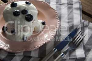 Delicious sweet food in plate with fork and butter knife
