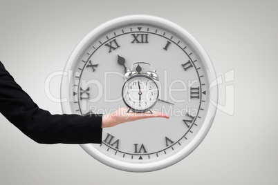 Business woman holding a clock against background with clock