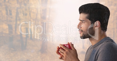 Man in Autumn with cup in bright forest