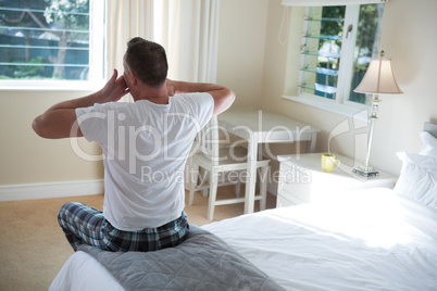 Man yawning in his bed