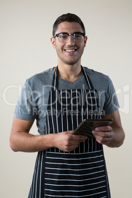Smiling waiter standing with a digital tablet Smiling waiter standing with a digital tablet
