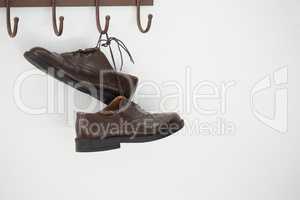 Pair of shoes hanging on hook