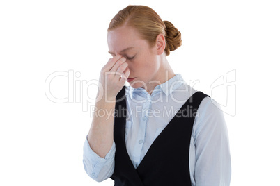 Upset female executive standing against white background