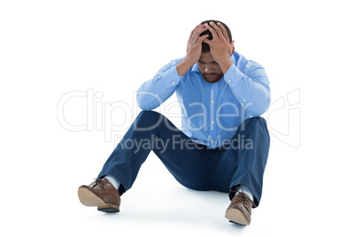 Male executive sitting against white background