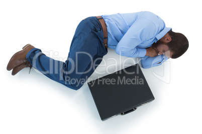 Male executive sleeping on white background