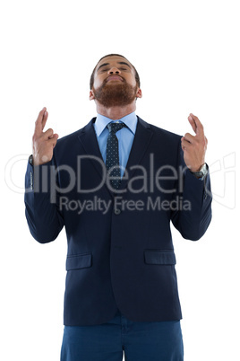 Businessman holding his finger crossed