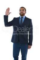 Businessman making stop sign against white background
