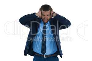 Irritated businessman covering his ears