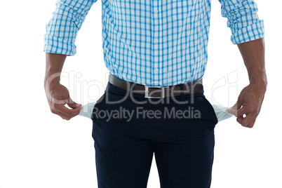 Male executive standing with empty pockets