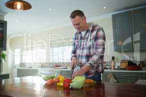 Man chopping vegetables in kitchen