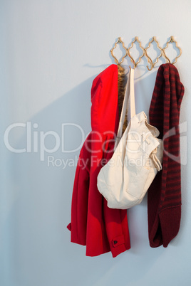 Warm clothes and bag hanging on hook