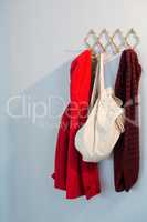 Warm clothes and bag hanging on hook