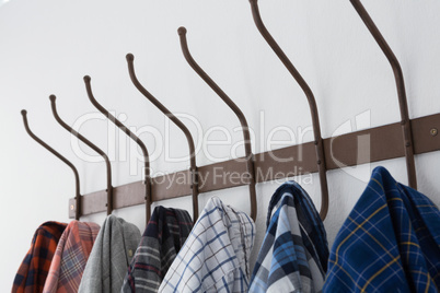 Close-up of various shirts hanging on hook