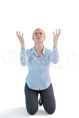 Businesswoman praying against white background