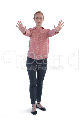 Female executive making stop sign against white background