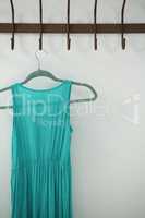 Close-up of turquoise dress hanging on hook