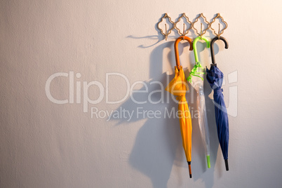 Colorful umbrellas hanging on hook