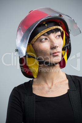 Female architect wearing helmet against white background