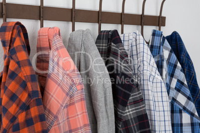 Close-up of various shirts hanging on hook